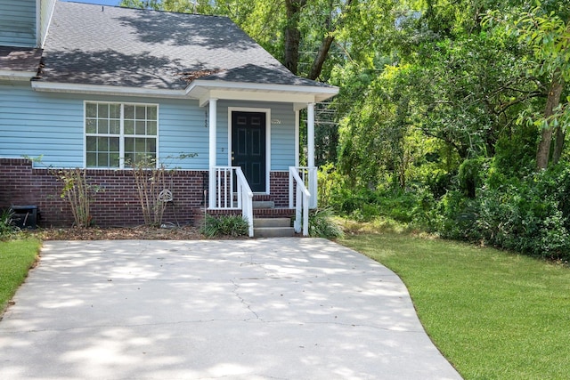 1997 Maymeadow Ln, Tallahassee, FL 32303 - view of front of property with brick siding, a front lawn, and a shingled roof