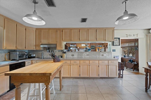 kitchen with black appliances, tasteful backsplash, pendant lighting, and light tile patterned floors