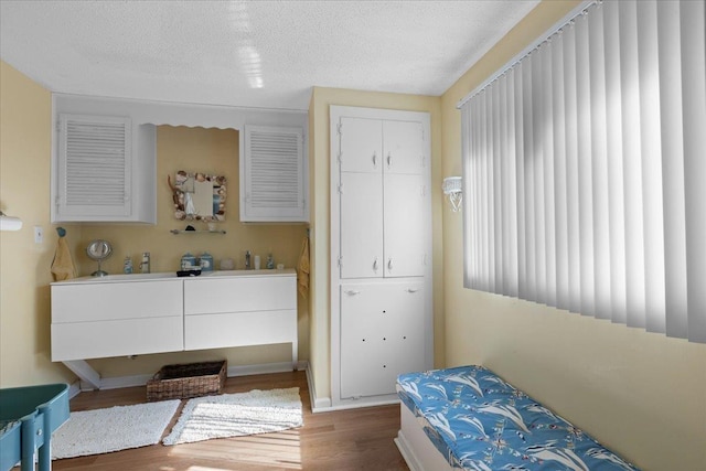 bedroom featuring dark wood-type flooring and a textured ceiling