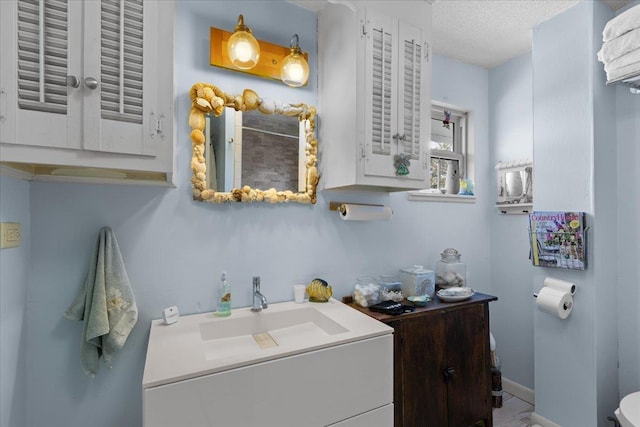 washroom featuring sink and a textured ceiling