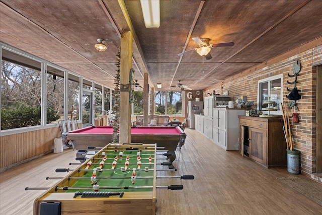 rec room with wood-type flooring, billiards, ceiling fan, and brick wall