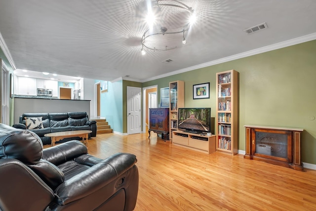 3514 Tullamore Ln, Tallahassee, FL 32309 - living room featuring light wood finished floors, crown molding, and stairs