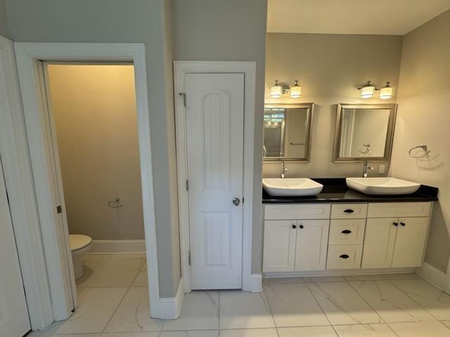 bathroom featuring vanity and toilet