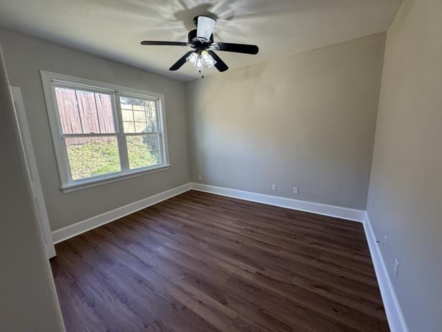 unfurnished room with dark hardwood / wood-style flooring and ceiling fan