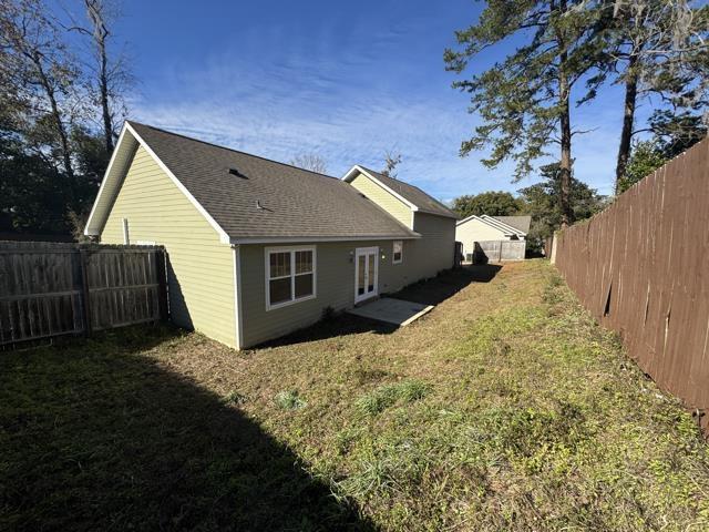 rear view of property with a yard