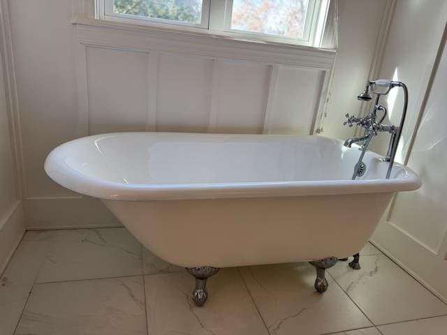 bathroom with a bathtub and plenty of natural light