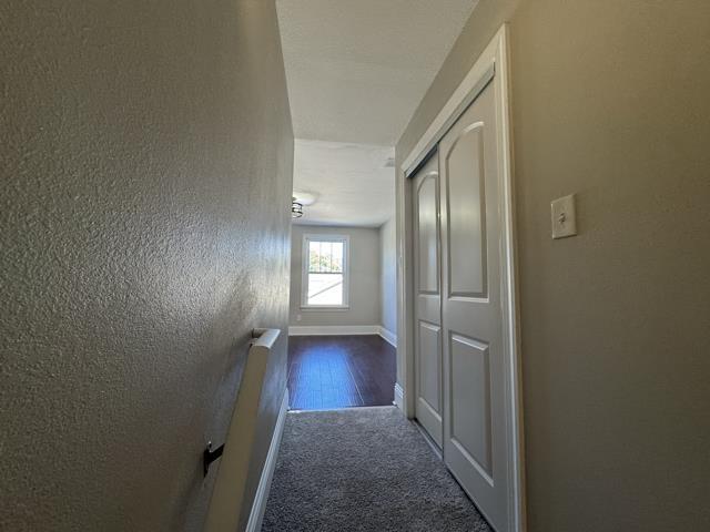 hallway with dark carpet