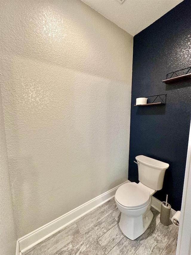 3646 Homestead Rd, Tallahassee, FL 32309 - bathroom featuring toilet, baseboards, and a textured wall
