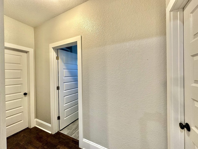 3646 Homestead Rd, Tallahassee, FL 32309 - corridor with a textured wall, dark wood-style floors, and a textured ceiling
