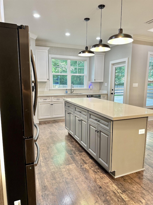 3646 Homestead Rd, Tallahassee, FL 32309 - kitchen featuring stainless steel appliances, ornamental molding, a sink, a kitchen island, and gray cabinetry