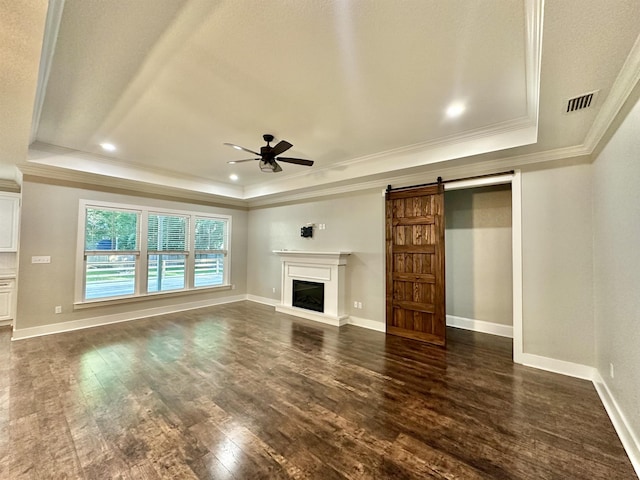 3646 Homestead Rd, Tallahassee, FL 32309 - unfurnished living room with a raised ceiling, crown molding, ceiling fan, a barn door, and dark wood-style floors