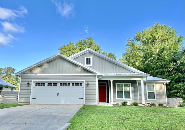 3646 Homestead Rd, Tallahassee, FL 32309 - view of front of home featuring driveway, an attached garage, and board and batten siding