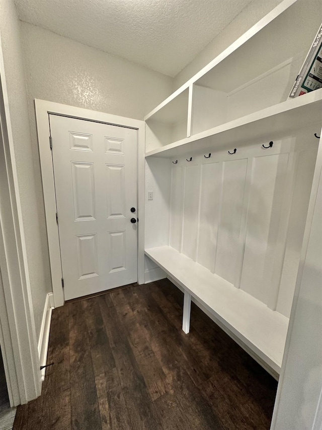 3646 Homestead Rd, Tallahassee, FL 32309 - mudroom with dark wood-style floors, a textured ceiling, and a textured wall