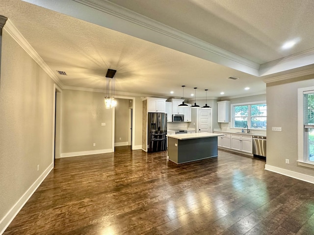 3646 Homestead Rd, Tallahassee, FL 32309 - kitchen with appliances with stainless steel finishes, a sink, a center island, light countertops, and white cabinetry
