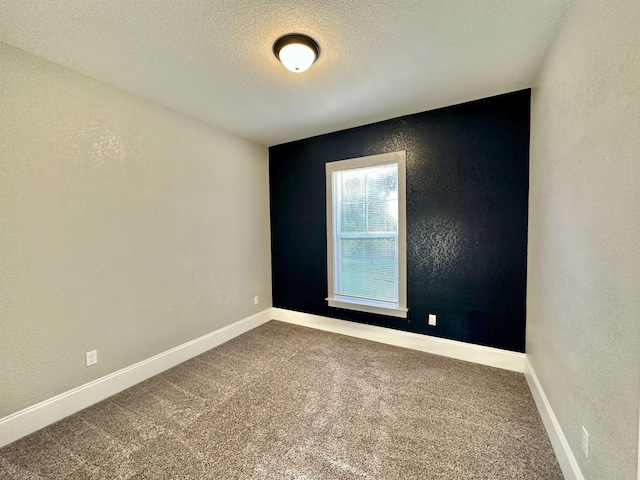 3646 Homestead Rd, Tallahassee, FL 32309 - carpeted empty room featuring a textured ceiling, baseboards, and a textured wall