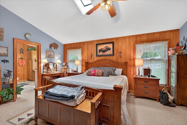 39 Wiregrass Ln, Quincy, FL 32351 - carpeted bedroom with vaulted ceiling, wooden walls, a skylight, and a ceiling fan
