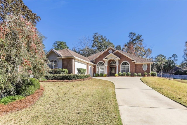 ranch-style home with a garage and a front yard