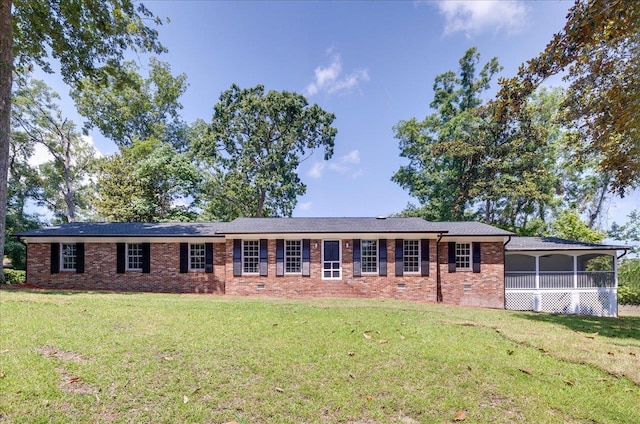 single story home featuring a front yard and a sunroom