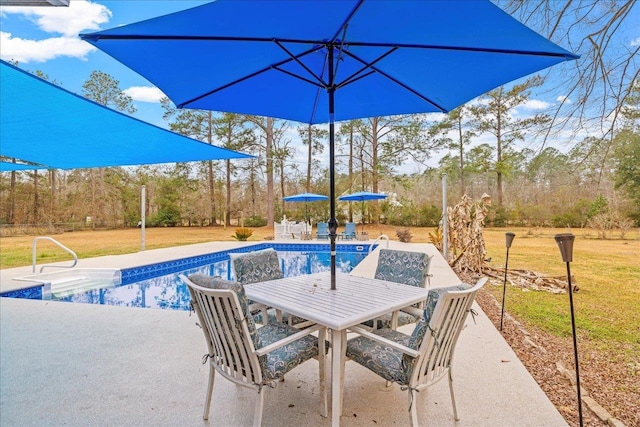 view of pool featuring a patio and a lawn