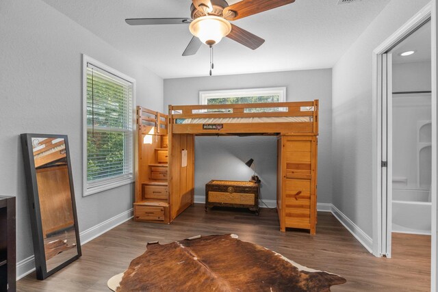 bedroom featuring dark hardwood / wood-style flooring and ceiling fan