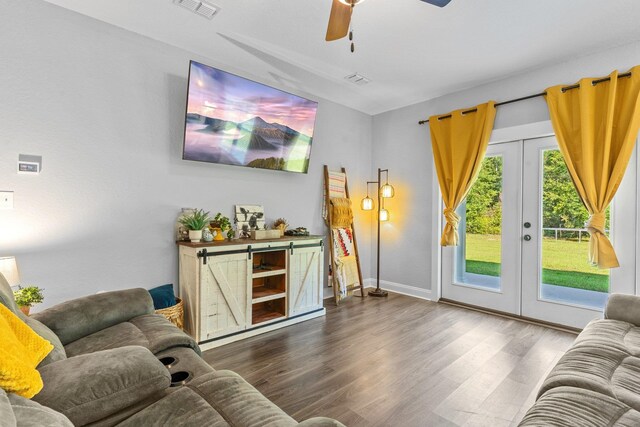 living room with dark wood-type flooring, ceiling fan, and french doors