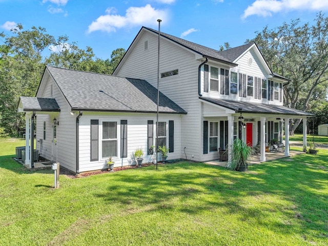 rear view of property with a yard