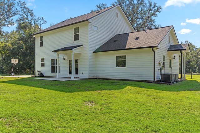 rear view of property featuring central air condition unit, a yard, and a patio area