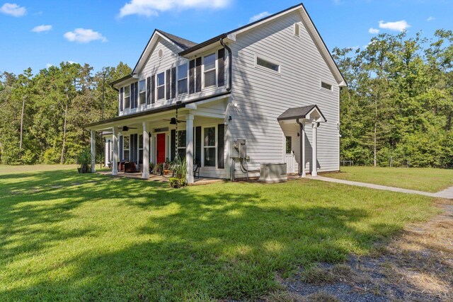 view of front of property featuring central AC unit, a front yard, and ceiling fan