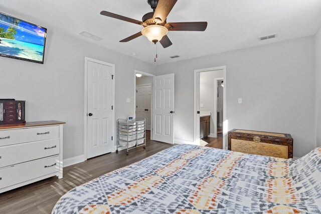 bedroom with connected bathroom, ceiling fan, and dark hardwood / wood-style floors