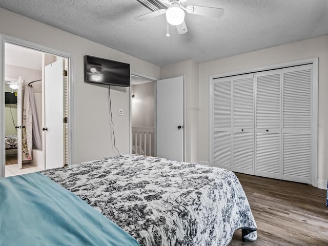 bedroom with hardwood / wood-style floors, a textured ceiling, and ceiling fan