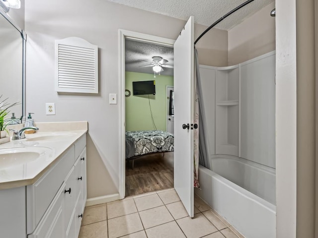 bathroom featuring vanity, a textured ceiling, shower / tub combo with curtain, ceiling fan, and tile patterned flooring