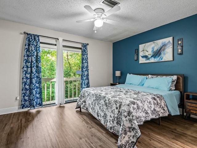 bedroom featuring access to outside, ceiling fan, a textured ceiling, and hardwood / wood-style flooring