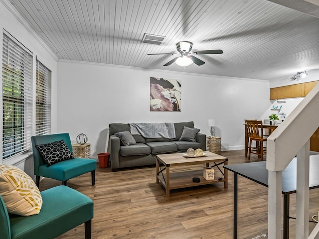 living room featuring hardwood / wood-style floors, ceiling fan, and ornamental molding