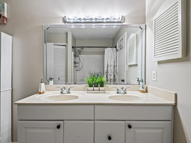 bathroom featuring curtained shower and vanity