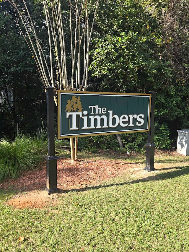 community / neighborhood sign with a lawn