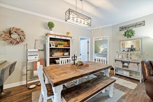 dining room with dark wood-type flooring, ceiling fan, and ornamental molding