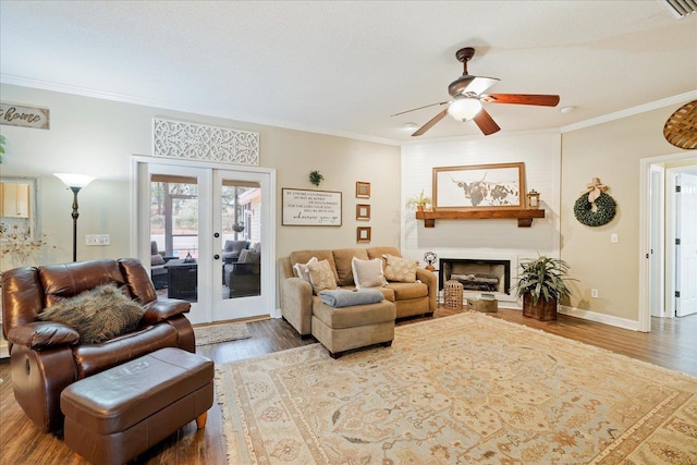 living room with french doors, ceiling fan, wood-type flooring, and crown molding