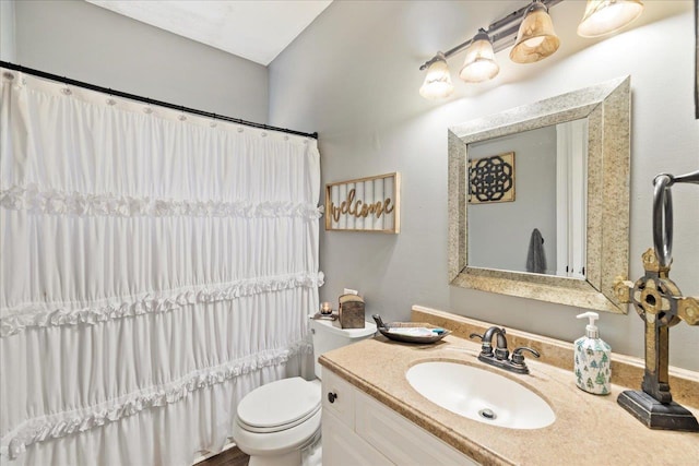 bathroom with a shower with curtain, vanity, and toilet