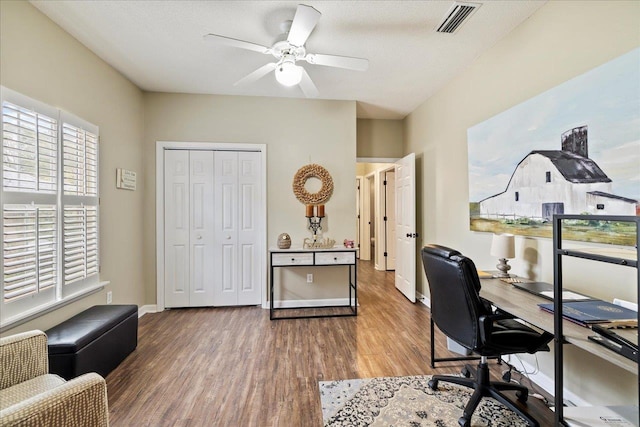 home office with hardwood / wood-style floors and ceiling fan