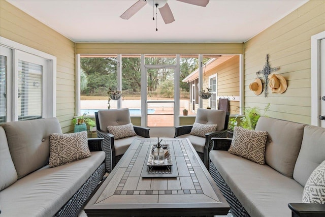 sunroom / solarium featuring ceiling fan