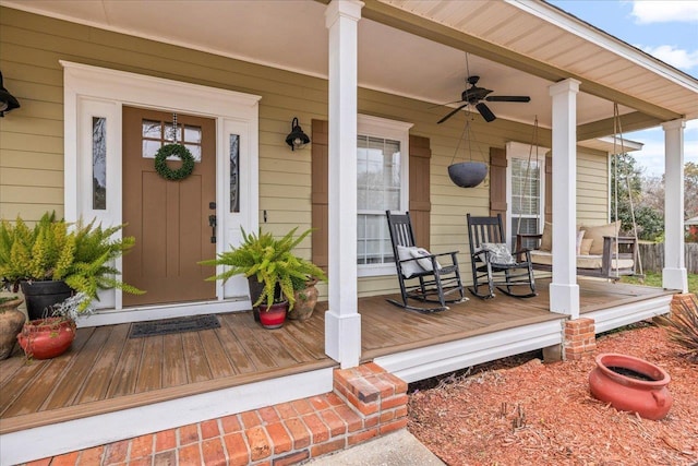 entrance to property featuring ceiling fan and a porch