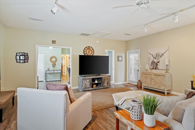 living room with ceiling fan, wood-type flooring, and track lighting