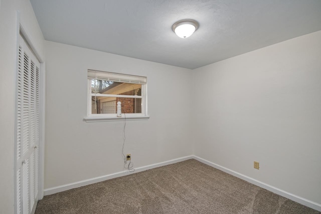 unfurnished bedroom with carpet floors, a closet, and baseboards