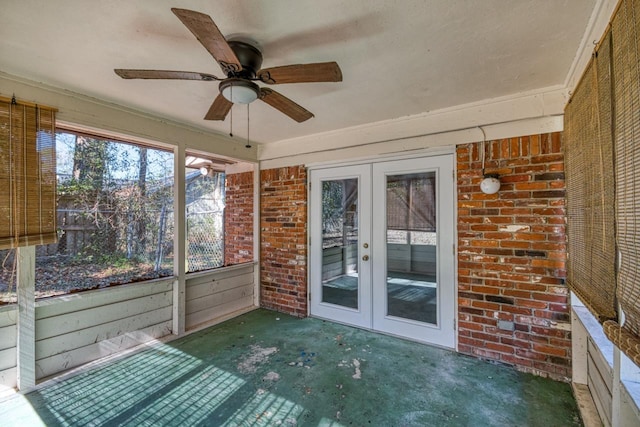 unfurnished sunroom with french doors and a ceiling fan