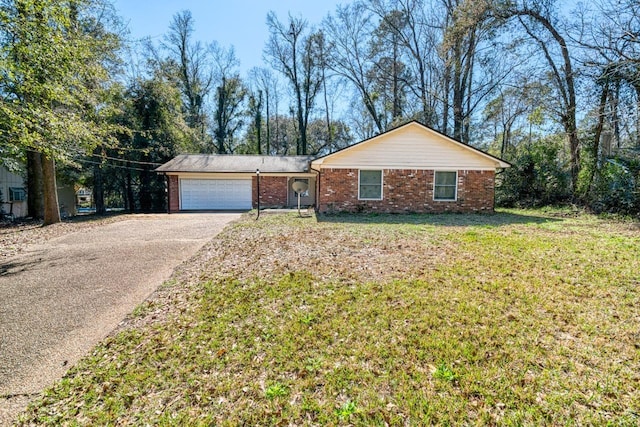 ranch-style home featuring an attached garage, driveway, a front lawn, and brick siding