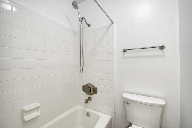 bathroom featuring washtub / shower combination and toilet