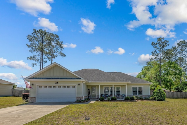 view of front facade with fence, concrete driveway, a front lawn, and a garage