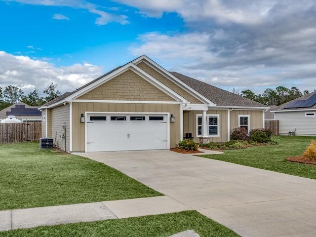 craftsman inspired home with central AC unit, a garage, and a front lawn