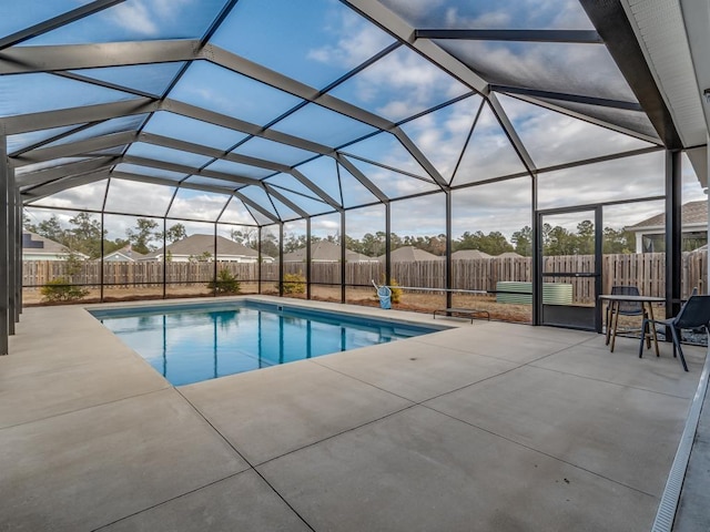 view of swimming pool with a patio area and a lanai