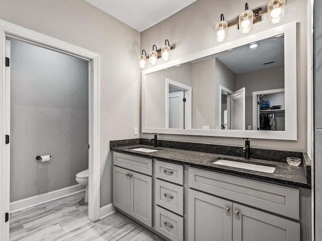 bathroom featuring vanity and toilet